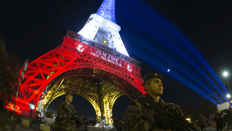The French flag colours light up the Eiffel Tower