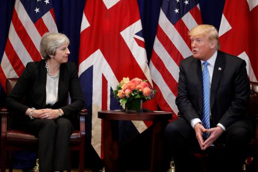 British Prime Minister Theresa May listens to U.S. President Donald Trump