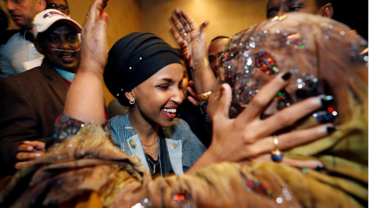 Ilhan Omar celebrates with other people