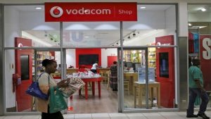 A shopper walks past a Vodacom shop in Johannesburg February 4, 2015.