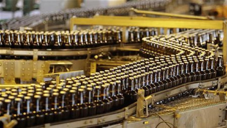 Bottles of beer move along a production line