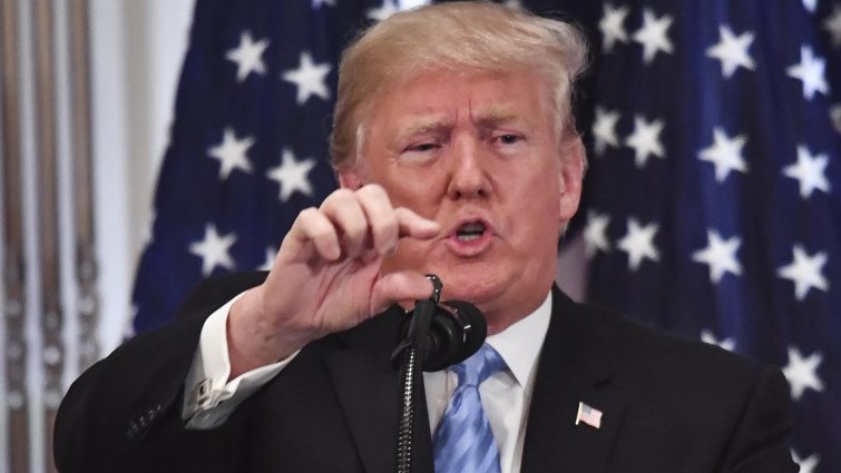 Donald Trump indicating something with his thumb and forefinger