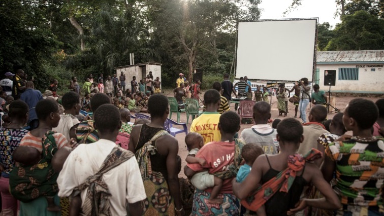 Many residents of a village of the Mbyaka (Pygmy) people gather in Bayanga after a trek for the cinema night