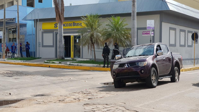 Police standing outside the bank where the attempted robbery took place.