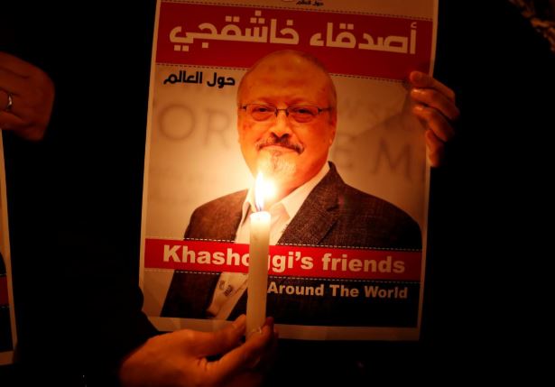 A demonstrator holds a poster with a picture of Saudi journalist Jamal Khashoggi outside the Saudi Arabia consulate in Istanbul, Turkey.