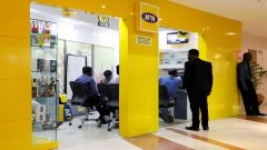 Customers are pictured inside an MTN dealer shop