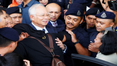 Najib Razak with security.