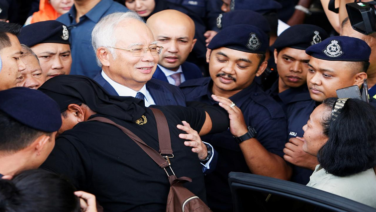 Najib Razak with security.