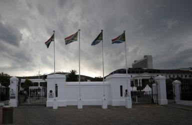 Flags fly outside Parliament in Cape Town, South Africa, February 13, 2018.