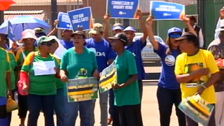 Women wearing  different political parties' regailia protested outside the High Court in Johannesburg on Wednesday.