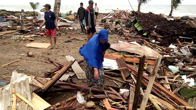 People picking up their destroyed houses