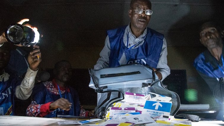 Independent National Electoral Commission (CENI) agents count votes during an electricity cut.