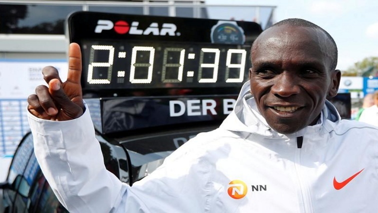 Kenya's Eliud Kipchoge celebrates winning the Berlin Marathon alongside a clock showing his World Record breaking time in Berlin, Germany - Sep 16, 2018.