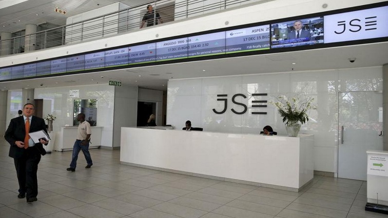 People walk near the reception at the Johannesburg Stock Exchange (JSE) in Sandton, Johannesburg, South Africa, file.