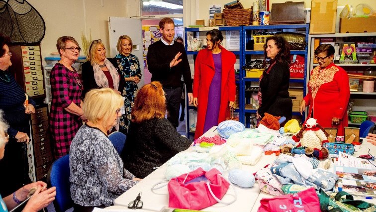 Britain's Prince Harry, Duke of Sussex (centre L) and Meghan, Duchess of Sussex (centre R), meet women as they visit Tomorrow's Women Wirral.