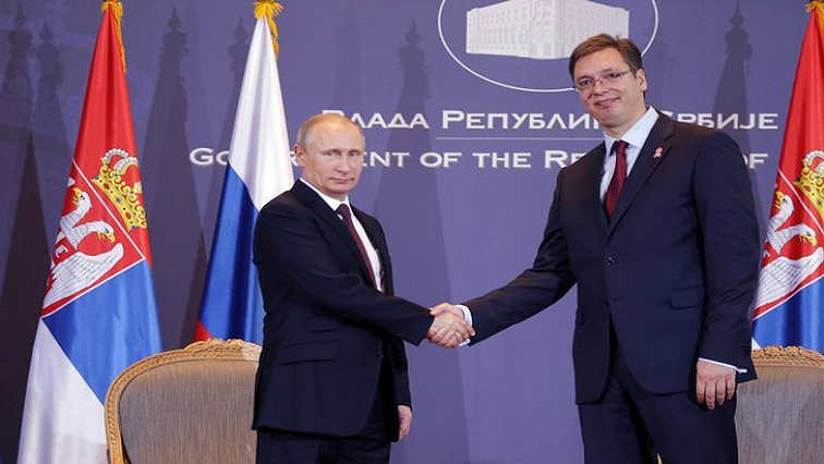 Russian President Vladimir Putin shakes hands with Serbian President Aleksandar Vucic