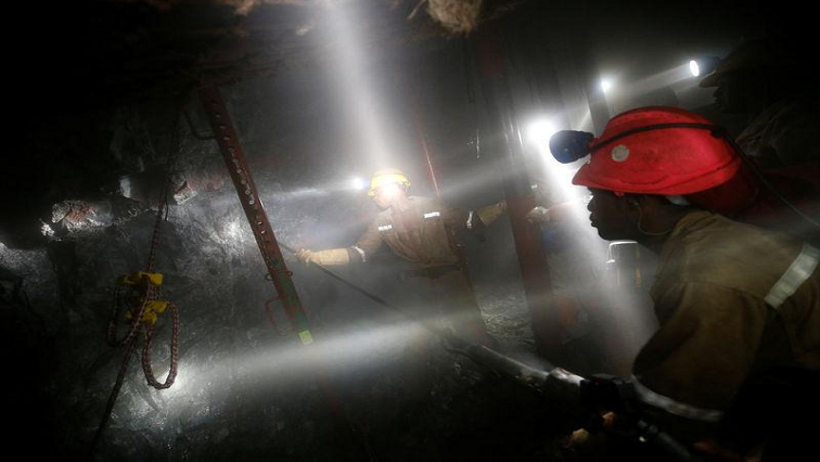 Mineworkers from Sibanye Gold's Masimthembe shaft operate a drill