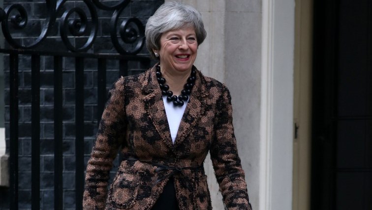 British Prime Minister Theresa May smiles as she leaves 10 Downing Street.