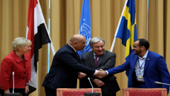 Head of Houthi delegation Mohammed Abdul-Salam and Yemeni Foreign Minister Khaled al-Yaman shake hands next to United Nations Secretary General Antonio Guterres and Swedish Foreign Minister Margot Wallstrom