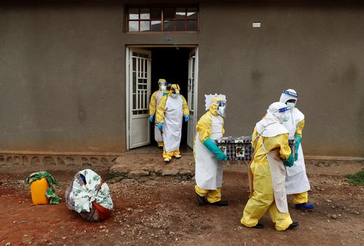 Healthcare workers carry a coffin with a baby, suspected of dying from Ebola, in Beni, North Kivu Province.