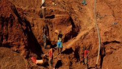 Illegal artisanal gold miners work at an open mine
