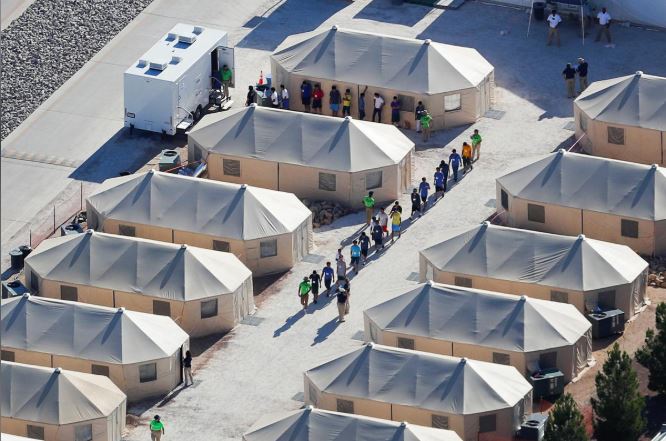 Immigrant children now housed in a tent encampment under the new "zero tolerance" policy by the Trump administration are shown walking in single file at the facility near the Mexican border.