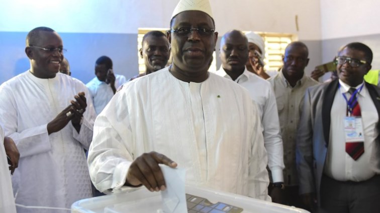 Incumbent President Macky Sall casts his vote for Senegal's presidential elections in a ballot box at a polling station in Fatick.