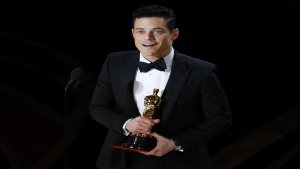 Rami Malek holding his Oscar