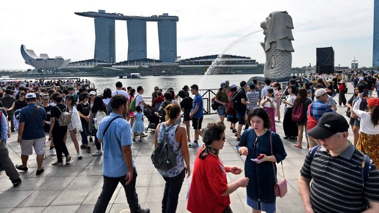 A crowd of people visiting central Singapore's iconic promenade. - Those in Singapore with HIV -- the virus that causes AIDS -- have long complained of prejudice, and campaigners say a data breach of some 14,200 people, whose HIV status was released on the internet in January 2019.