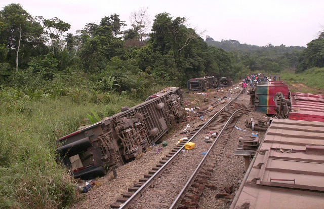 Overturned carriages lie near the rail track in Yanga, Congo-Brazzaville, after seventy-six people were killed in Monday's rail disaster. The Congo-Brazzaville government on Tuesday issued a provisional toll of 48 dead and more than 400 injured in the accident, and said the search for more bodies would continue.