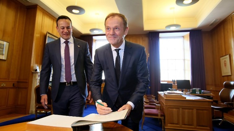 Irish Prime Minister Leo Varadkar (L) accompanies President of the European Council Donald Tusk (R) as Tusk signs the visitor's book.