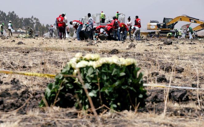 Members of the Ethiopian red cross search for remains at the Ethiopian Airlines Flight ET 302 plane crash before a commemoration ceremony at the scene of the crash, near the town of Bishoftu, southeast of Addis Ababa.