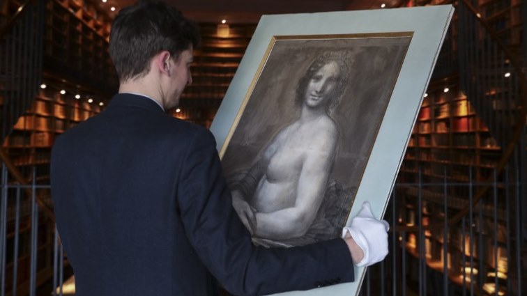 Curator at the Conde Museum Mathieu Deldicque holds a charcoal drawing known as the "Monna Vanna", also dubbed "The Nude Mona Lisa" (La joconde nue), during the artwork's presentation to the press.