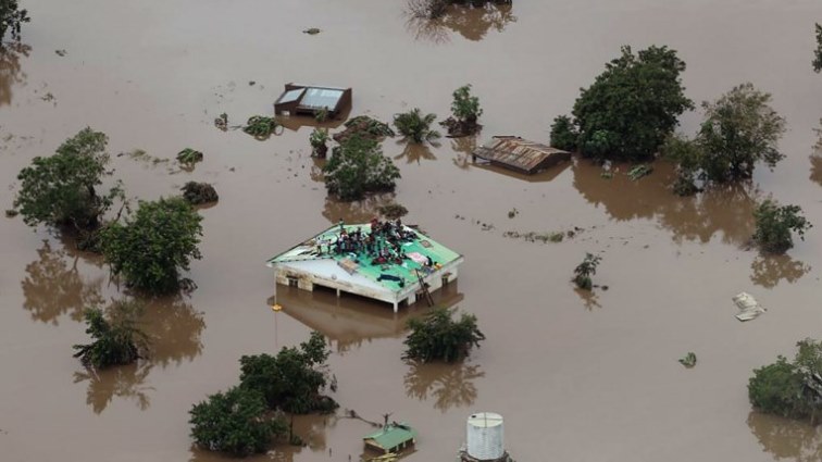 The Mission Aviation Fellowship picture shows people on a roof surrounded by flooding in an area affected by Cyclone Idai in Beira.