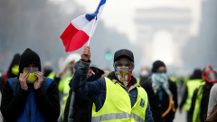 Yellow vest protester holding French flag