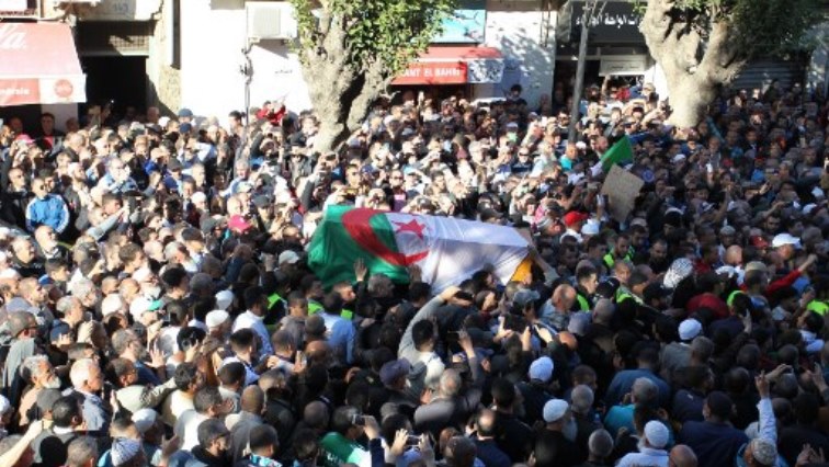 Mourners carry the coffin of Abassi Madani, founder of Algeria's banned Islamic Salvation Front (FIS).