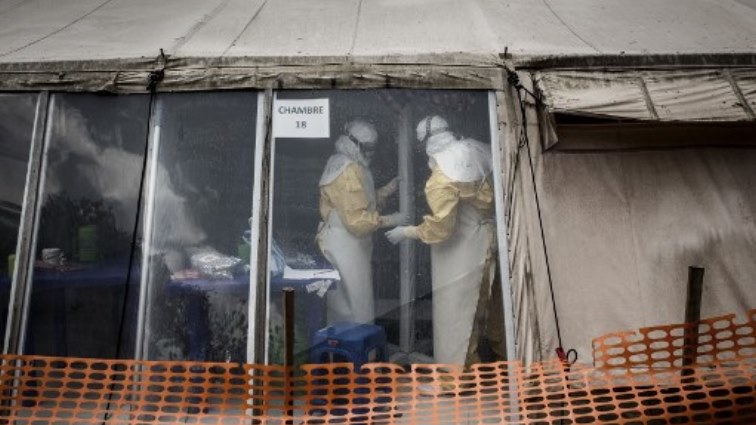 Health workers are seen inside the 'red zone' of an Ebola treatment centre.