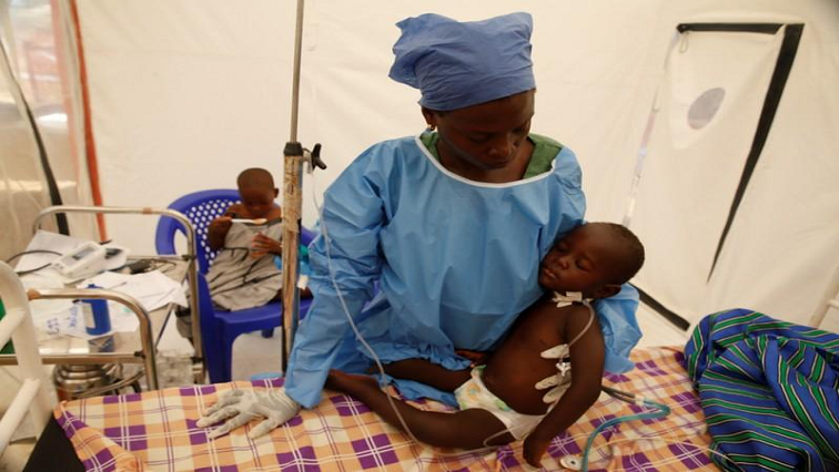 Ebola survivor Jeanine Masika holding two-year-old ebola patient, Furana Katungu