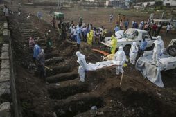 Health workers carry the body of an Ebola victim for burial at a cemetery in Freetown.