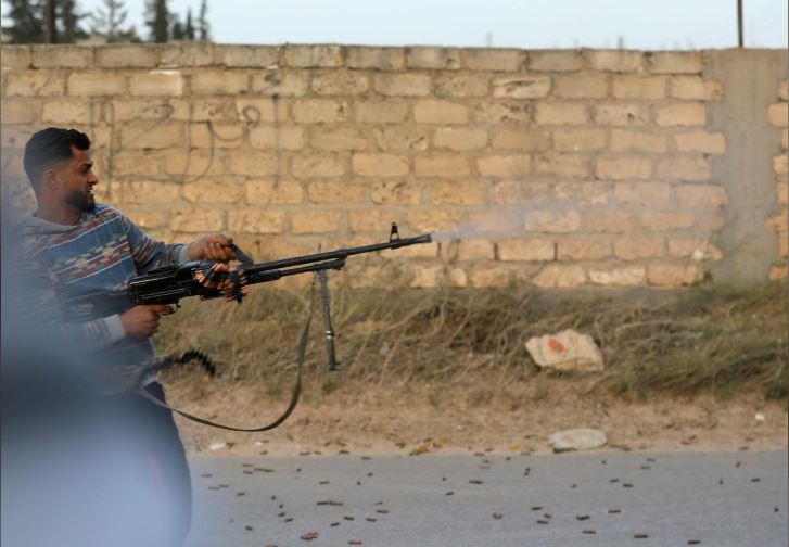 A member of the Libyan internationally recognised government forces fires during fighting with Eastern forces in Ain Zara.