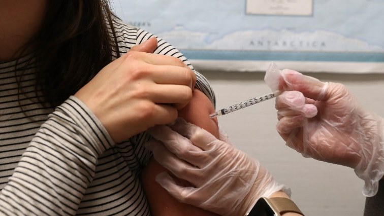 A woman is being vaccinated