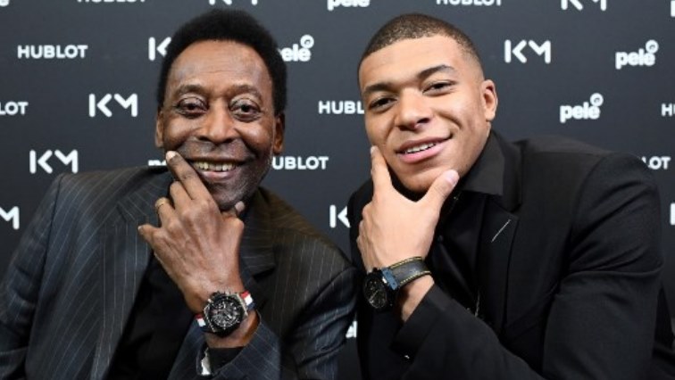 Paris Saint-Germain (PSG) and France national football team forward Kylian Mbappe (R) and Brazilian football legend Pele pose during their meeting at the Hotel Lutetia in Paris.