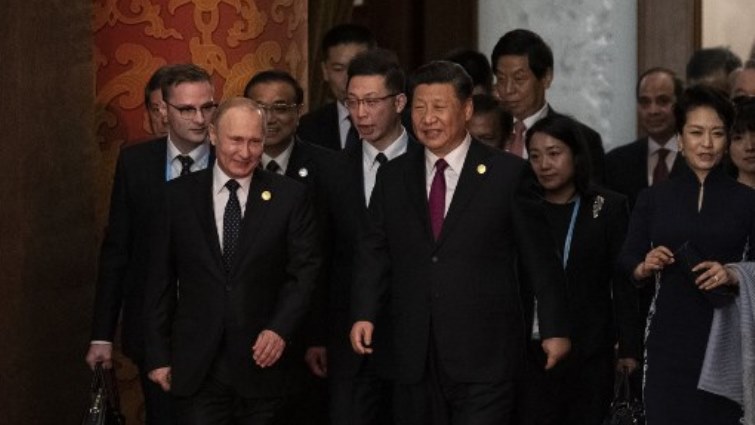 Russia's President Vladimir Putin (front L) and China's President Xi Jinping (C) arrive for the welcome banquet for leaders.