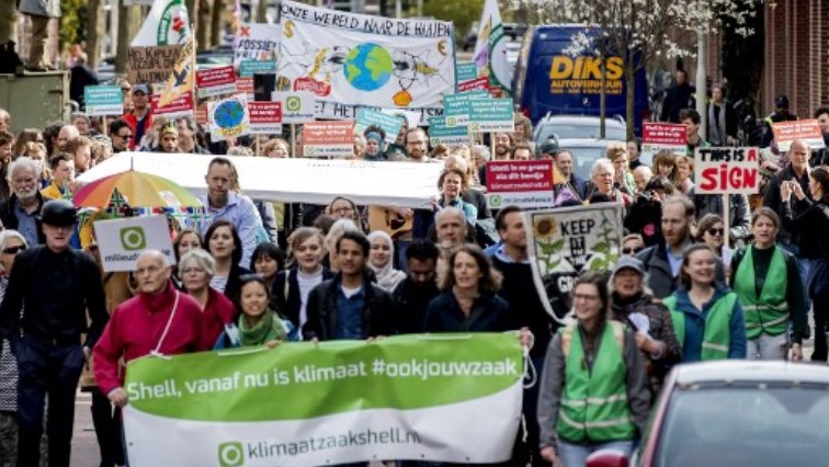 Dozens of activists march toward Shell's base in The Hague, on April 5, 2019 where they will deliver a legal summons with a court date set for April 17.