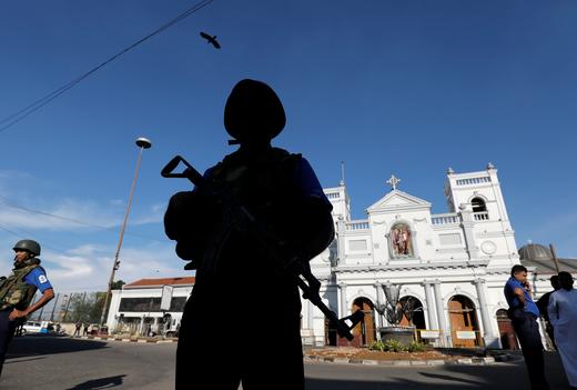 A security officer stands guard in front of St Anthony's shrine in Colombo, after bomb blasts ripped through churches and luxury hotels.