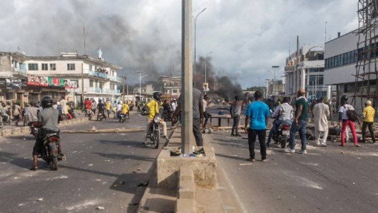 Smoke rises from barricades as demonstrators gather for a protest in the streets of Cadjehoun, district of former president of Benin Thomas Boni Yayi, as demonstrators gather  in Cotonou.