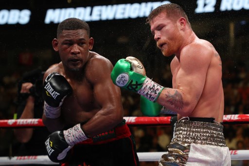 Daniel Jacobs (L) punches Canelo Alvarez during their middleweight unification fight at T-Mobile Arena on May 04, 2019 in Las Vegas, Nevada.