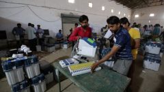 Election staff check Voter Verifiable Paper Audit Trail (VVPAT) machines and Electronic Voting Machines (EVM) ahead of India's general election at a warehouse in Ahmedabad.