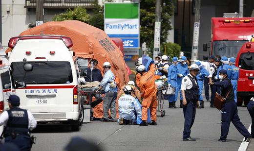 Rescue workers and police officers operate at the site