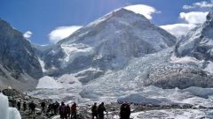 Climbers walk towards their helicopter (not seen) after their Mount Everest expeditions were cancelled